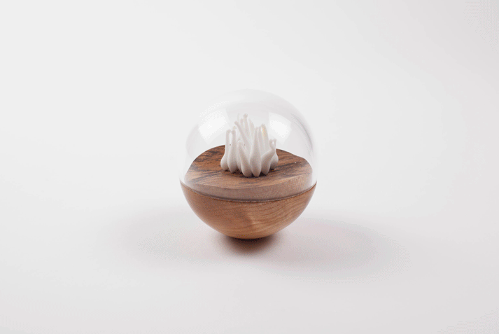 Un/Natural 1 Rotating video of half wood, half glass orbs with glass lichen inside